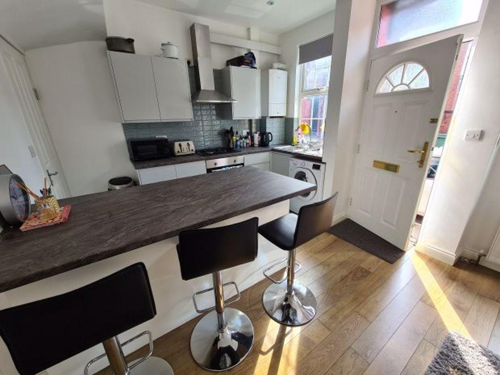 Bright and modern kitchen area featuring a brea...