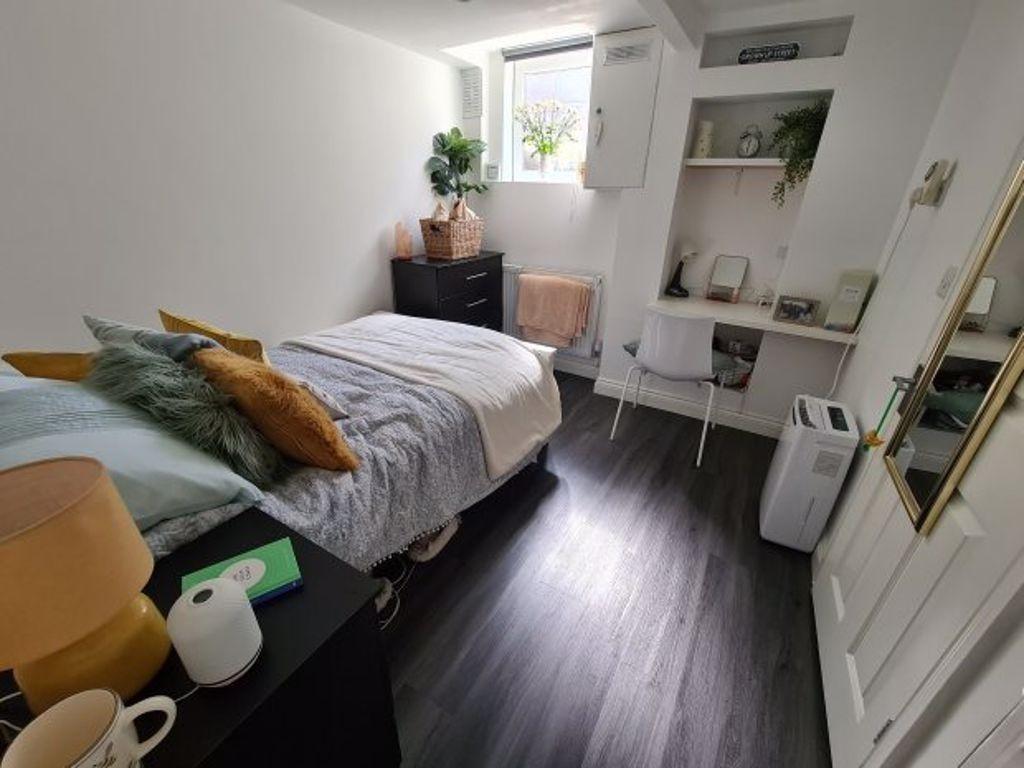 A bright, well-maintained bedroom featuring a c...