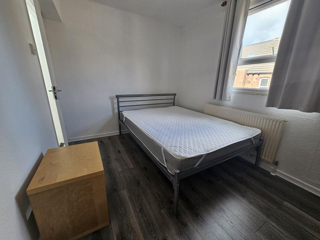 A neatly presented single bedroom with minimal ...