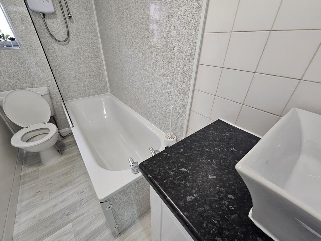A clean and well-maintained bathroom with a bat...