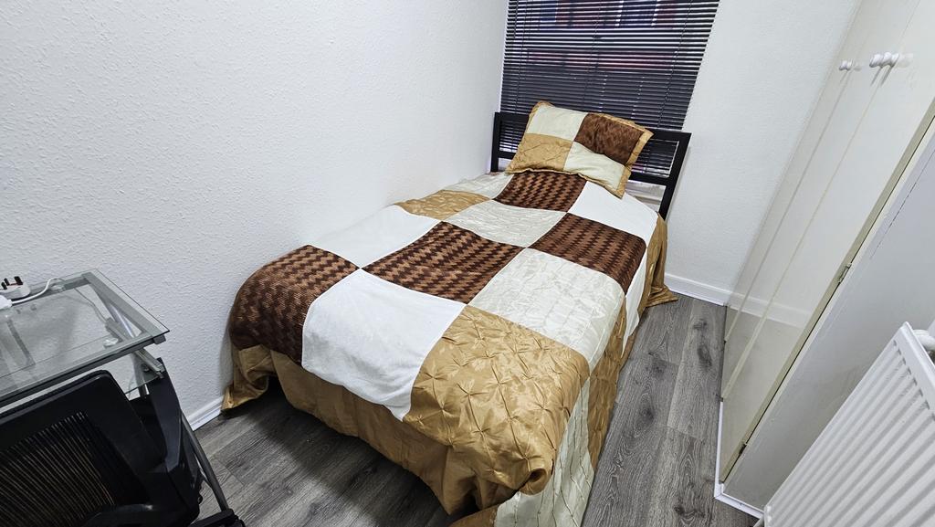 A neatly made double bedroom with a comfortable...
