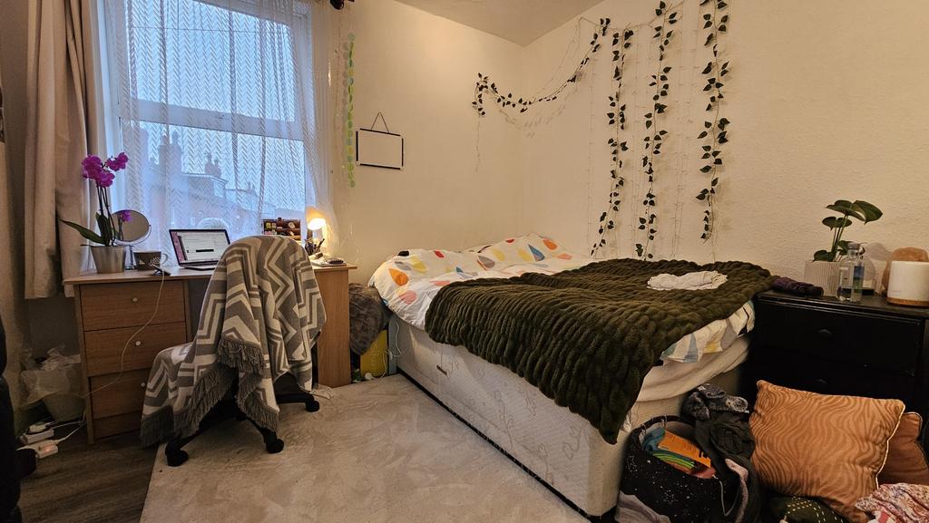 A spacious and inviting bedroom featuring a lar...