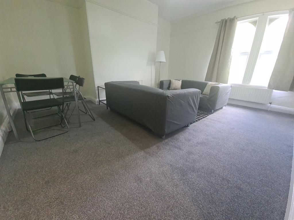 A bright and welcoming living room featuring a ...