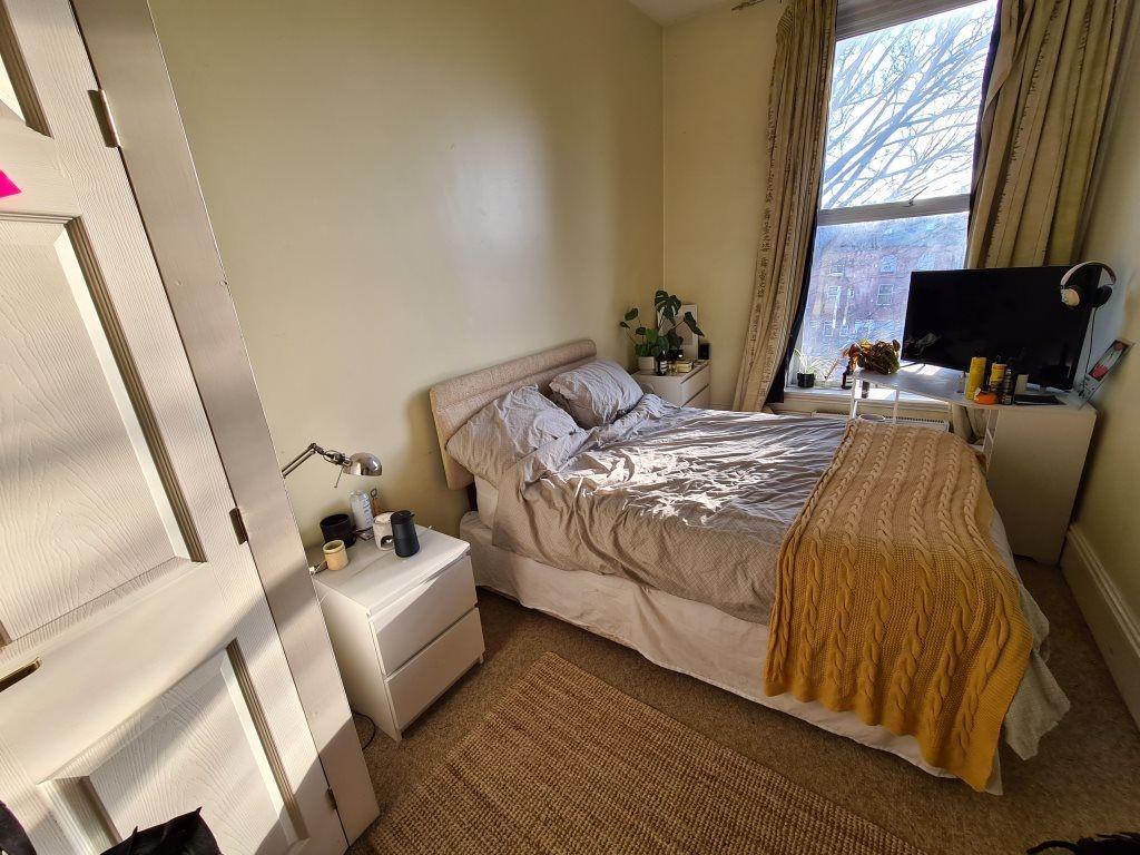 A bright and welcoming master bedroom featuring...