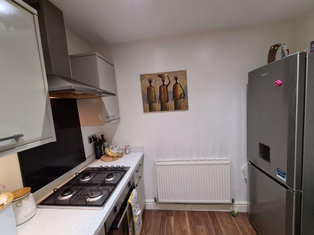 A modern kitchen with white cabinets, a gas sto...