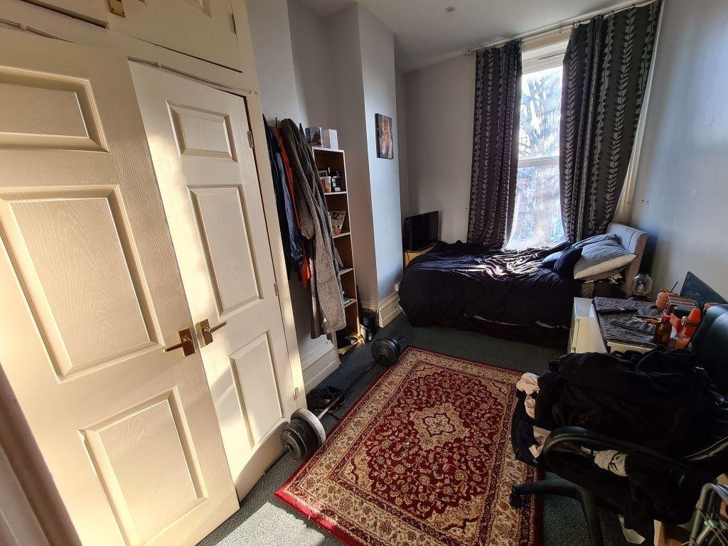 A cozy bedroom featuring a double bed, with nat...