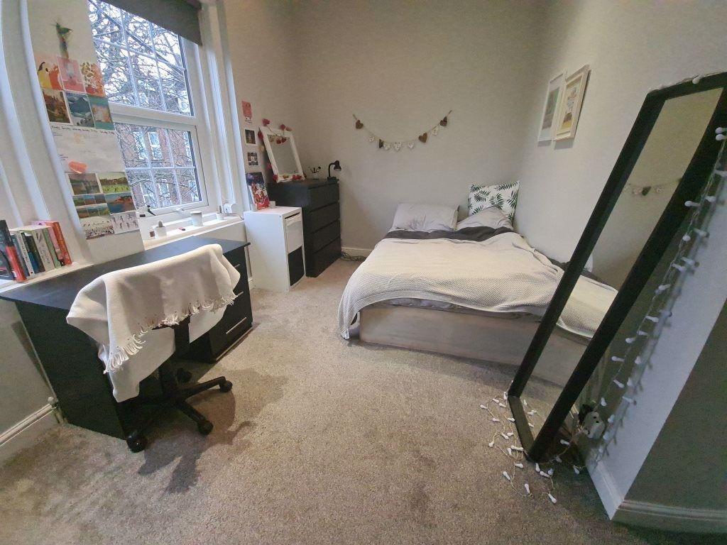 A cozy and inviting bedroom with natural light ...