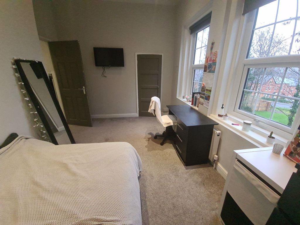A bright and welcoming bedroom featuring a doub...