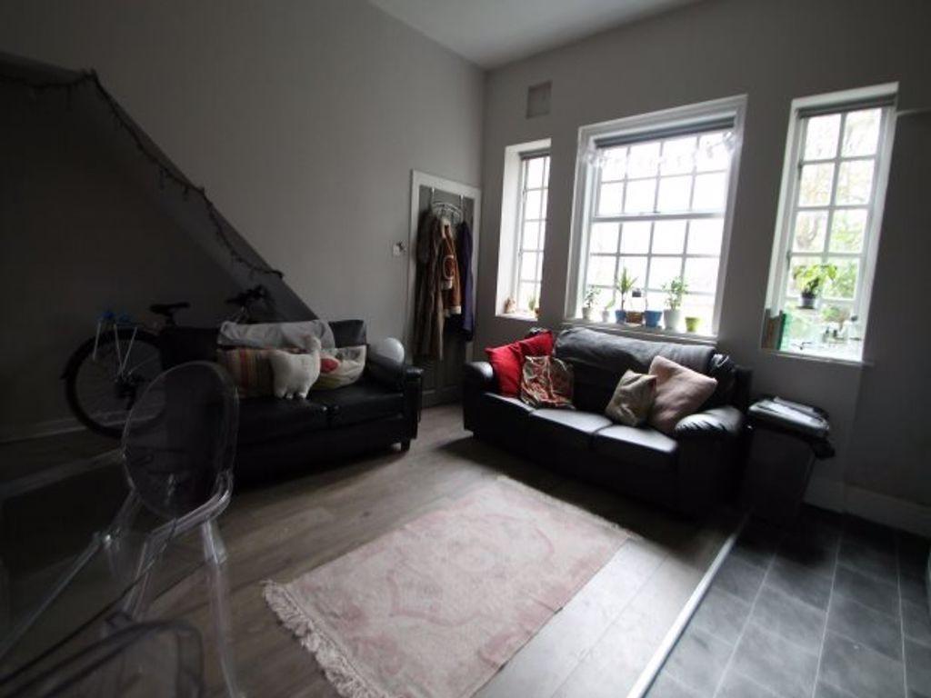 A well-lit, modern living room featuring two bl...