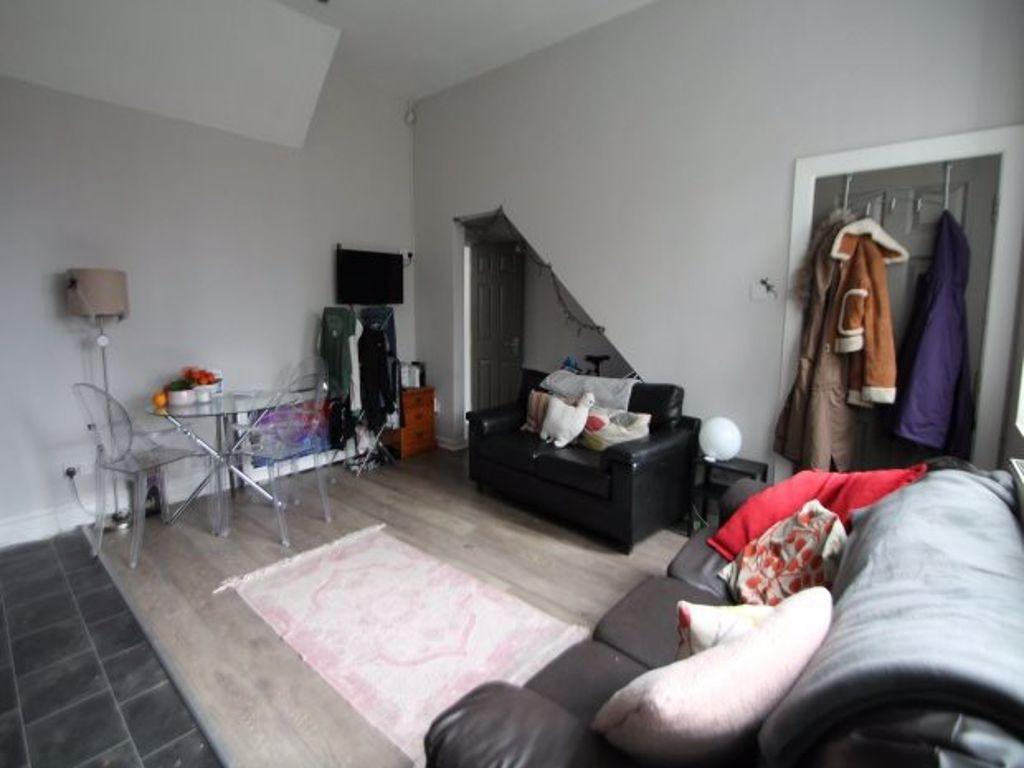 A spacious and well-lit living room with modern...