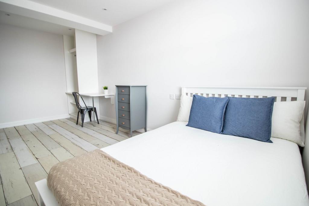Bright and welcoming master bedroom featuring a...