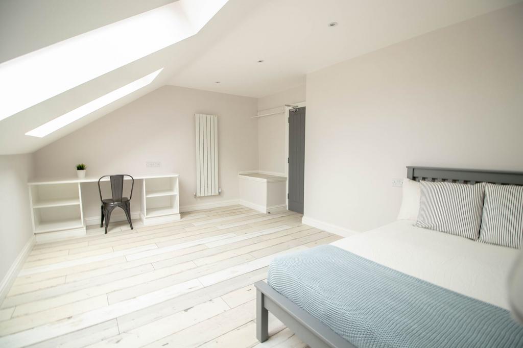Bright and spacious master bedroom featuring a ...