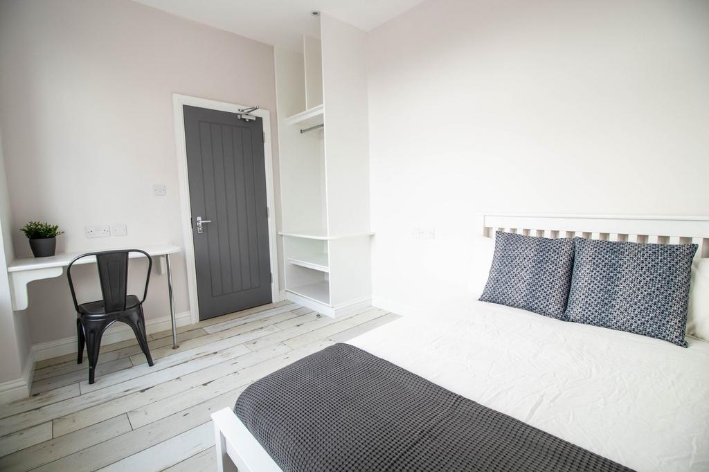 Bright and inviting bedroom featuring a comfort...