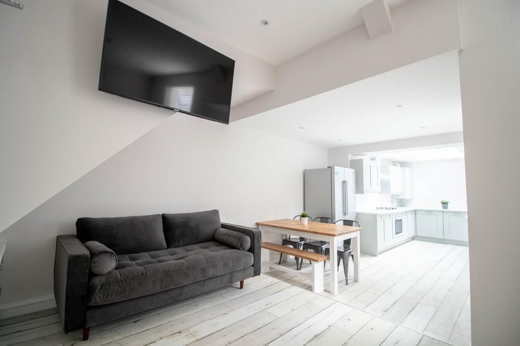 Bright and contemporary living room featuring a...