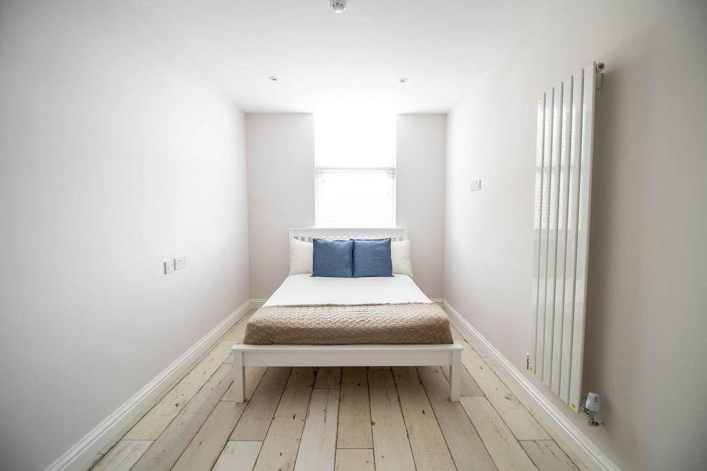 Bright and spacious master bedroom featuring a ...