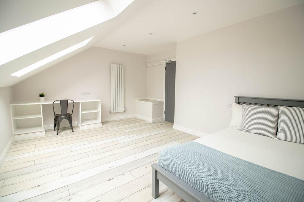Bright and airy master bedroom with a sleek, mi...