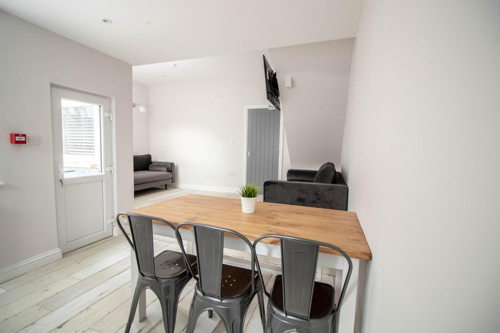 Bright and modern living room featuring a comfo...