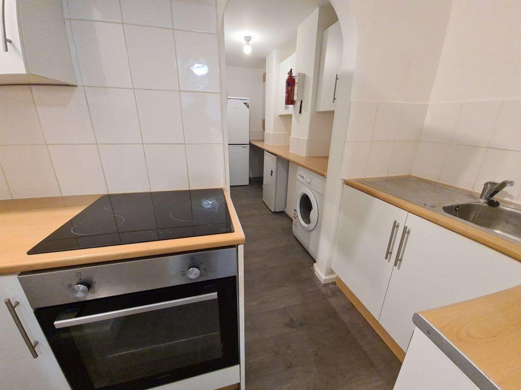 A bright and functional kitchen features modern...