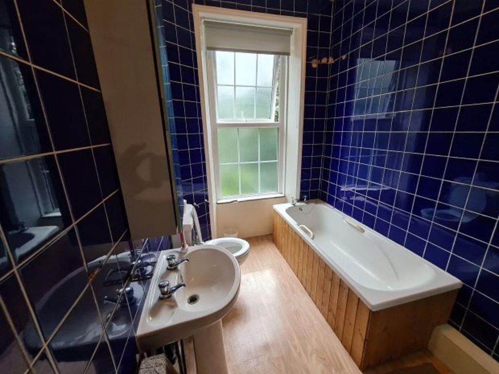 A clean and spacious bathroom featuring a large...