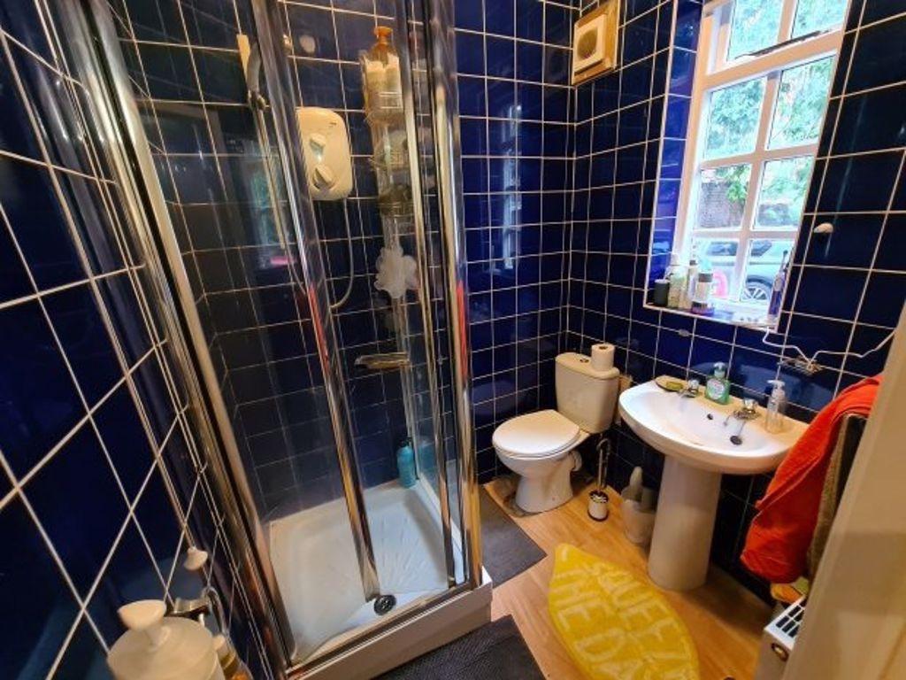 A well-maintained bathroom featuring a glass sh...