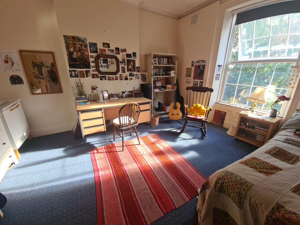 Bright and cozy living room featuring large win...