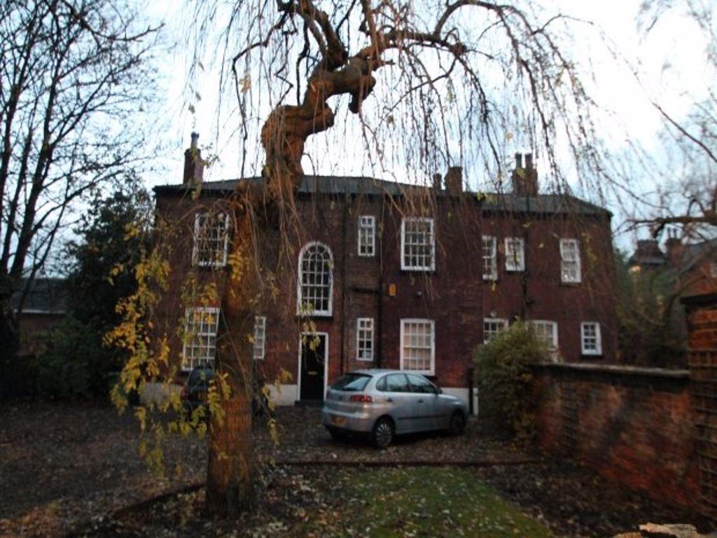 The exterior view of a charming brick house wit...