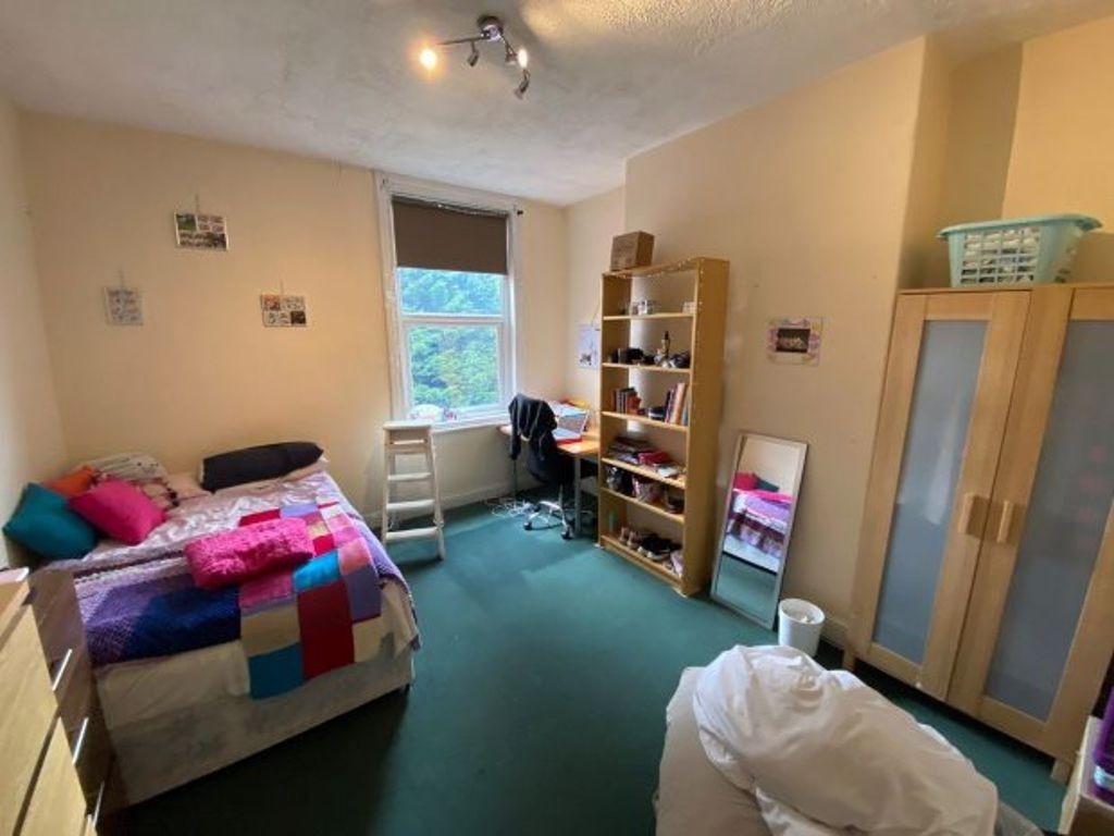 A cozy bedroom featuring a double bed, with a b...
