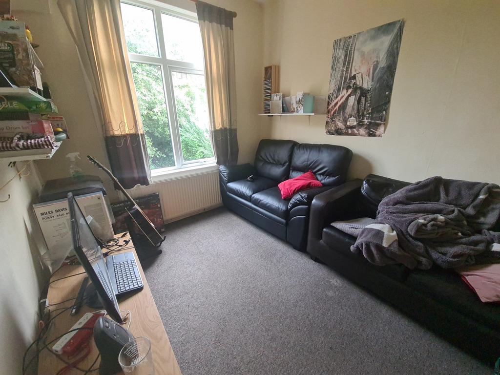 Cozy living room with comfortable black leather...