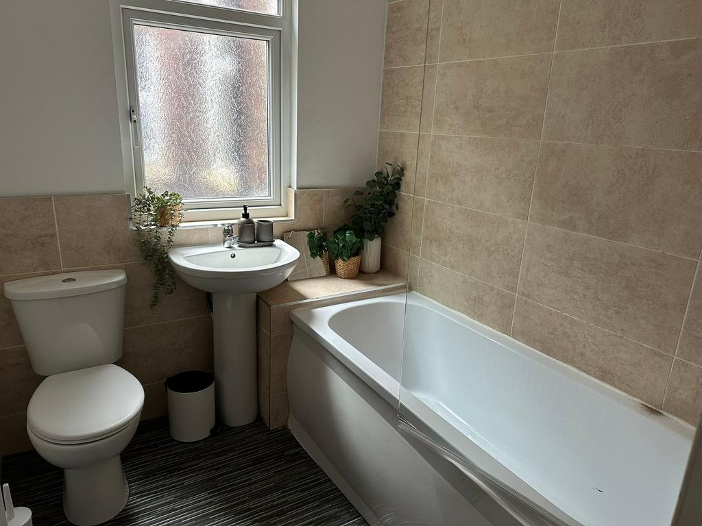 A clean and modern bathroom featuring a white t...