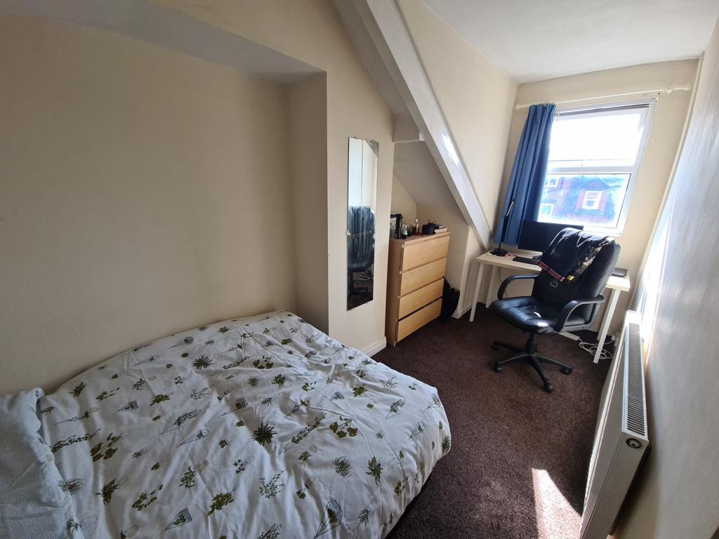 Bright and welcoming double bedroom featuring a...