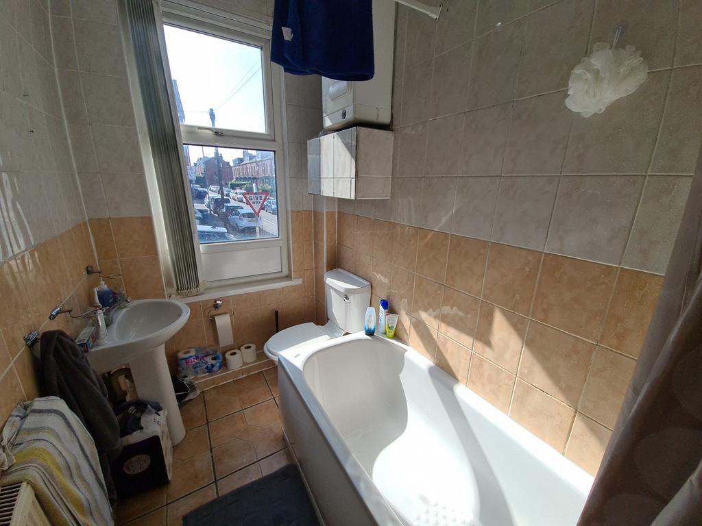 A bright and clean bathroom with a spacious bat...