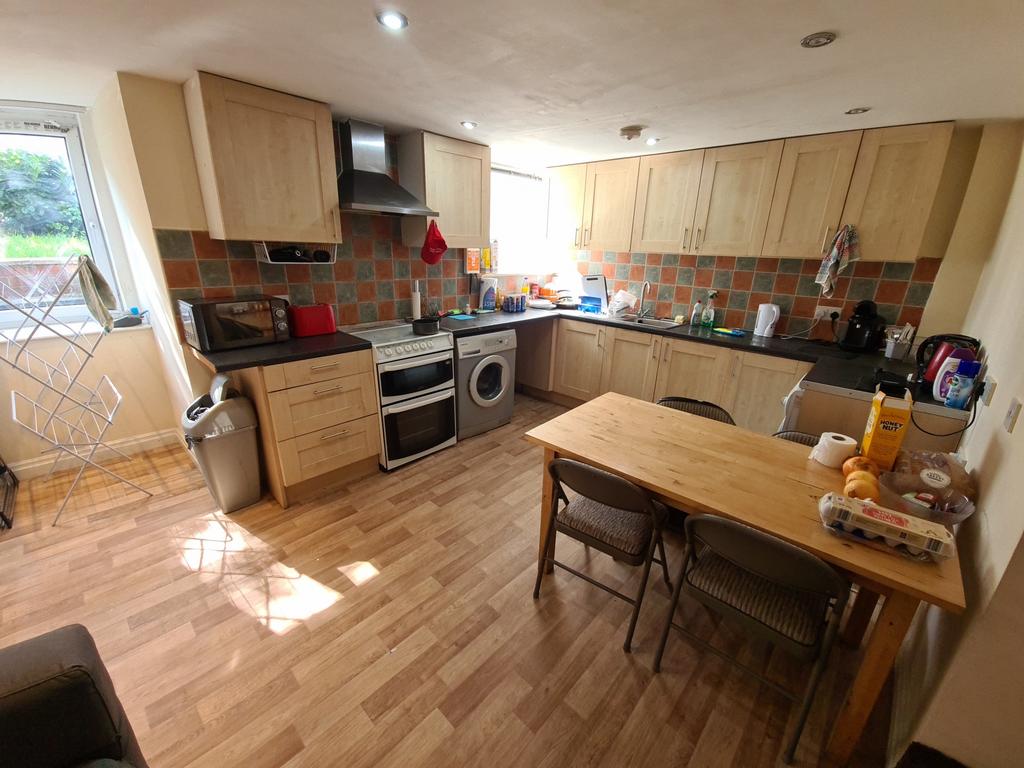 Bright and welcoming kitchen with ample cabinet...