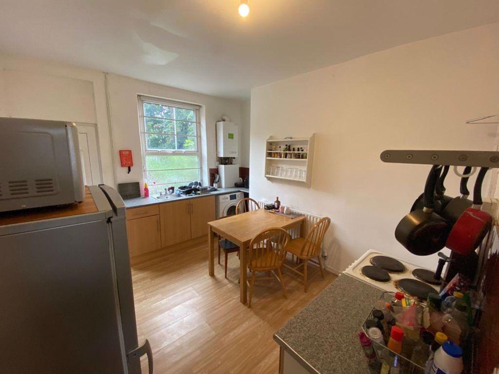 A well-lit and tidy kitchen area with modern ap...