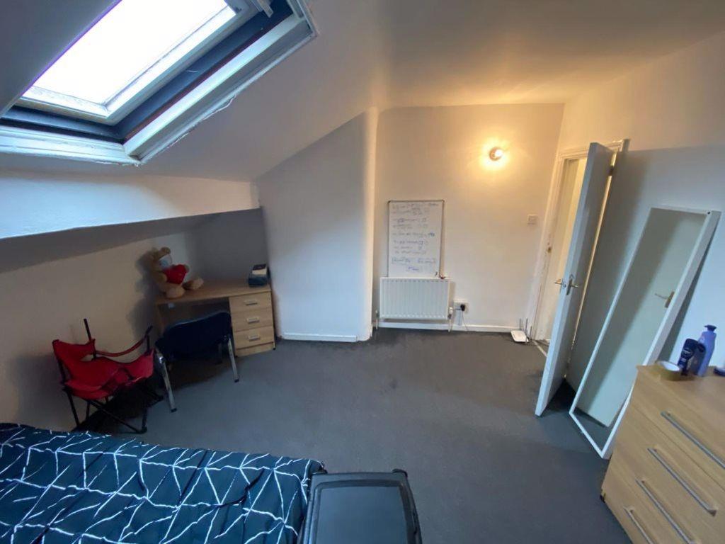 A bright, well-maintained bedroom with a window...