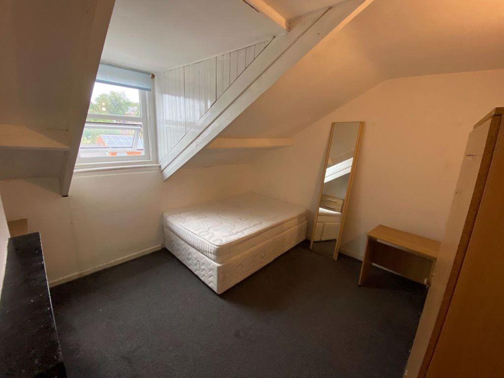 A cozy student bedroom featuring a single bed, ...