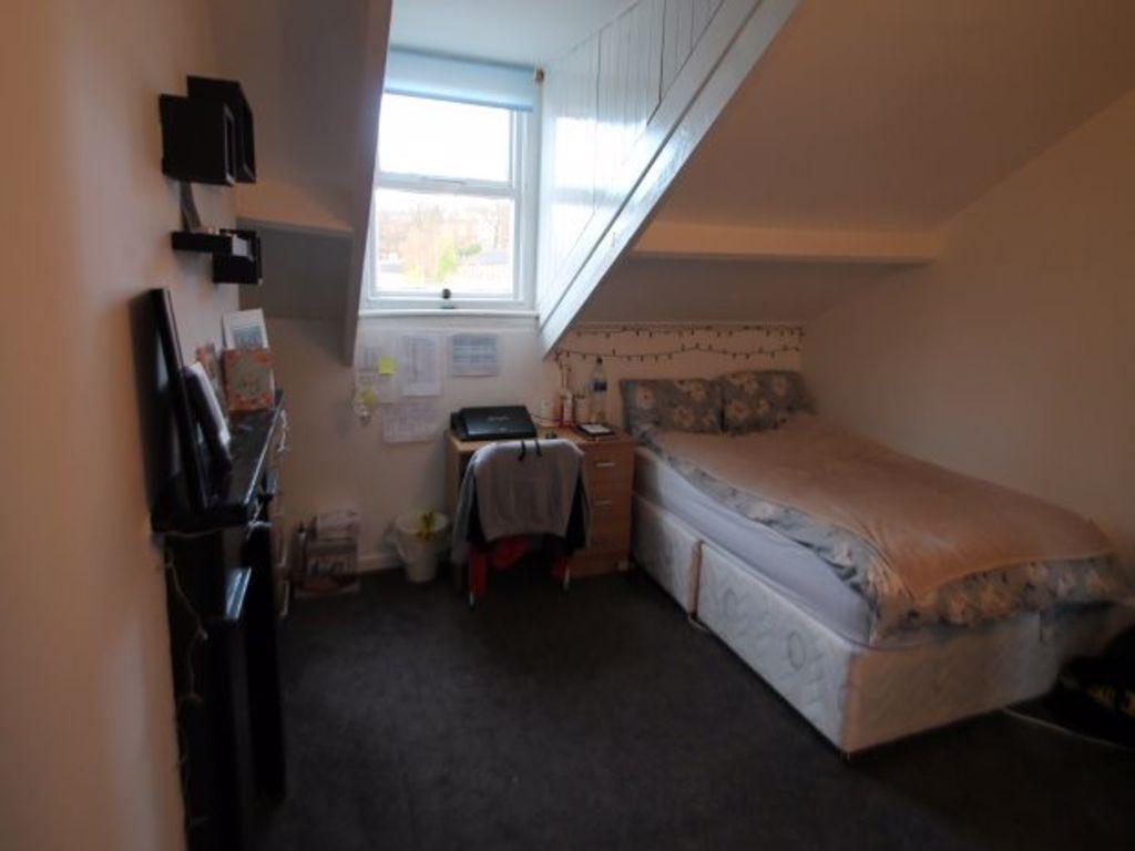 A cozy bedroom with a double bed, a window allo...