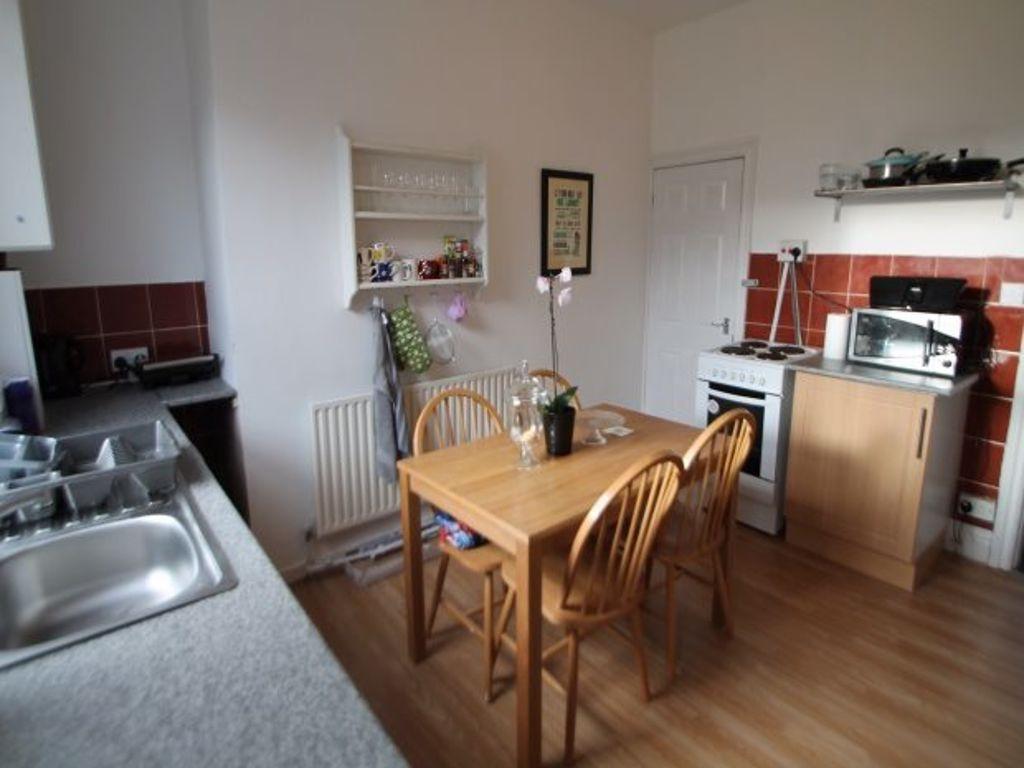 A bright and clean kitchen with a wooden dining...