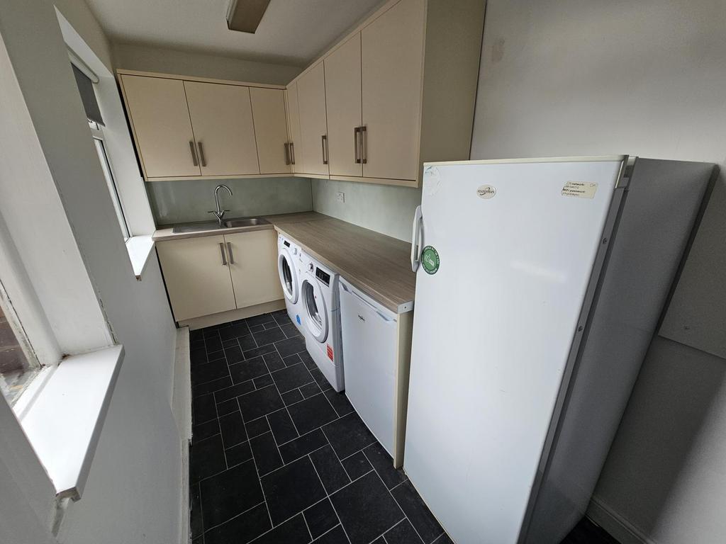 A bright and practical kitchen space featuring ...