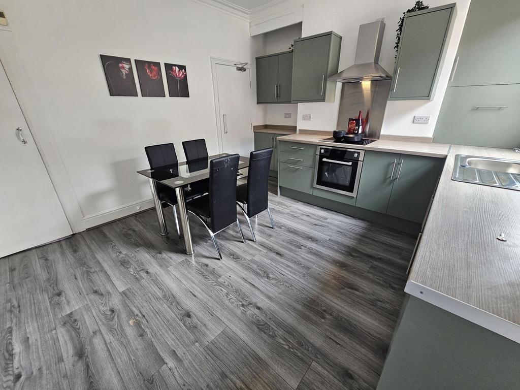 A modern, well-maintained kitchen with sleek ca...