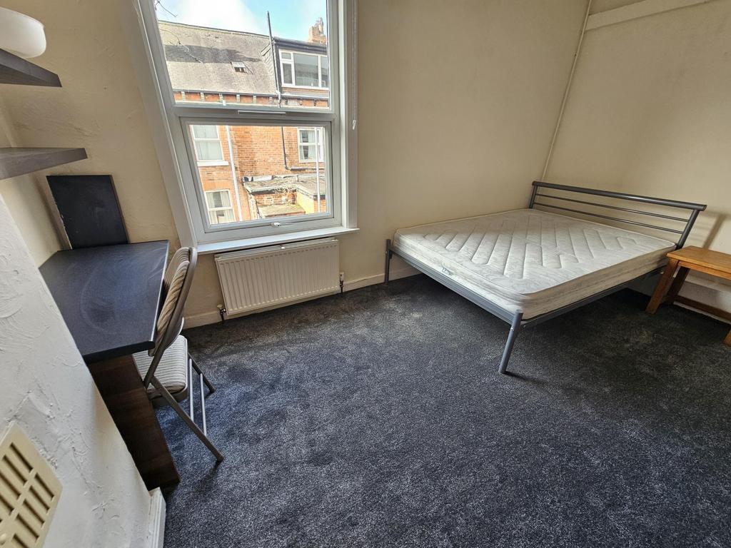 A compact and bright student room with a single...