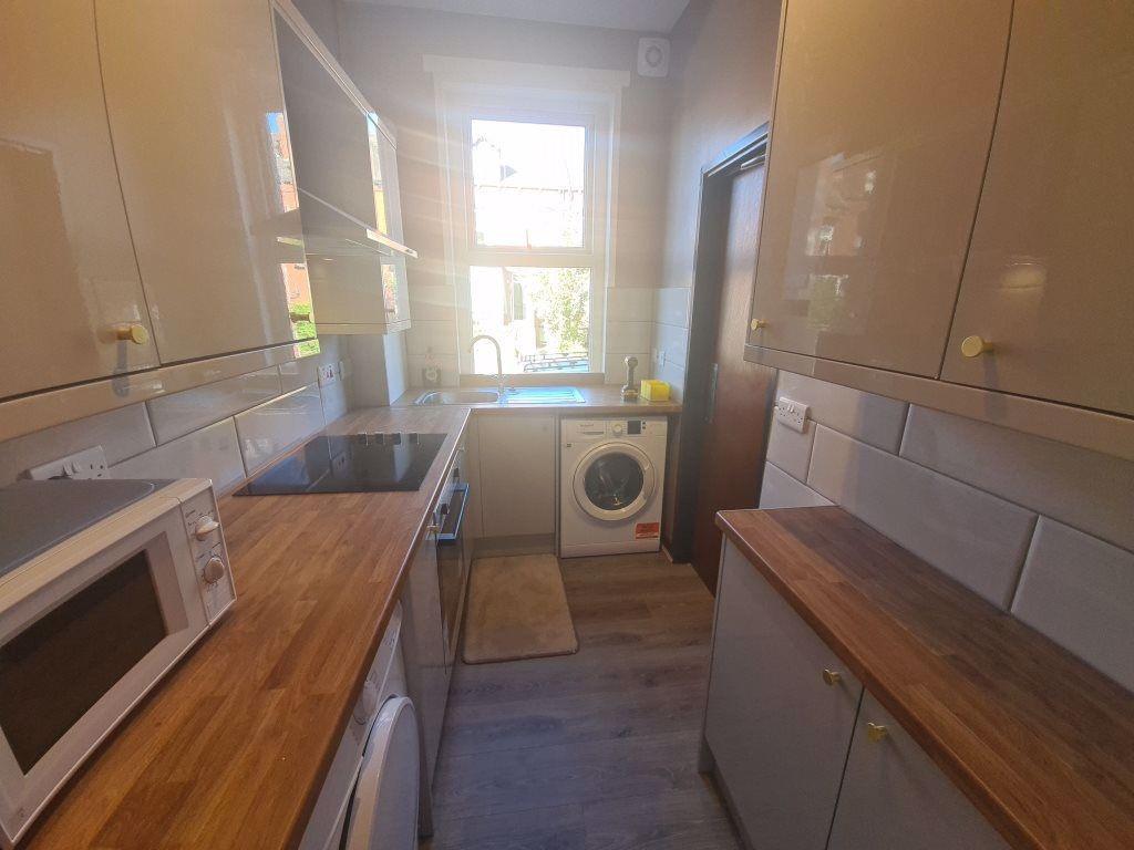 Bright and clean kitchen featuring ample counte...