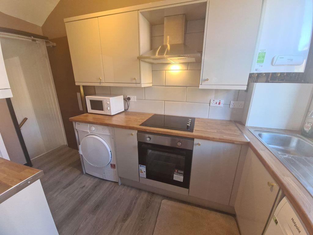 A modern kitchen area featuring a clean counter...