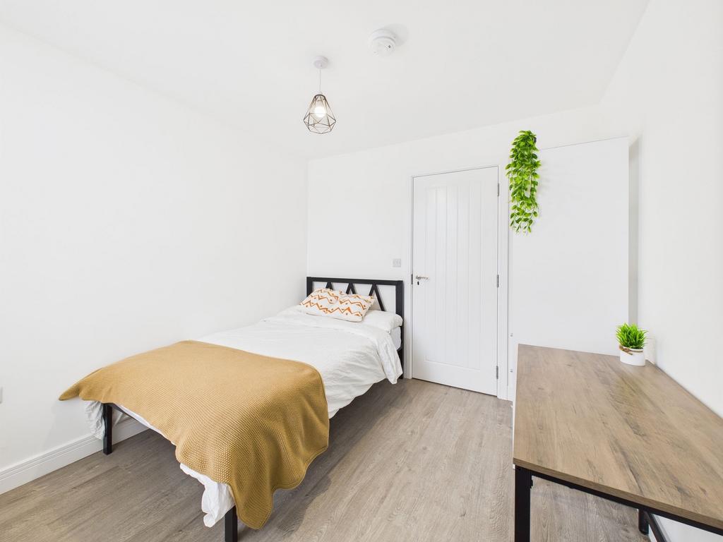 A bright and inviting single bedroom featuring ...