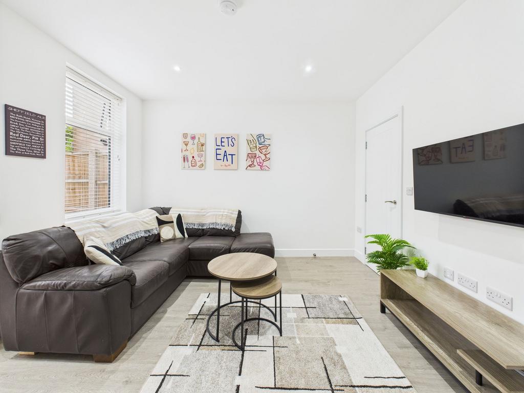 Bright and modern living room featuring a comfo...