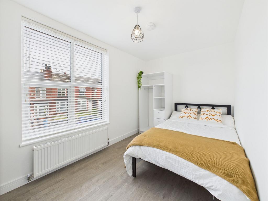 Bright and inviting double bedroom with a large...