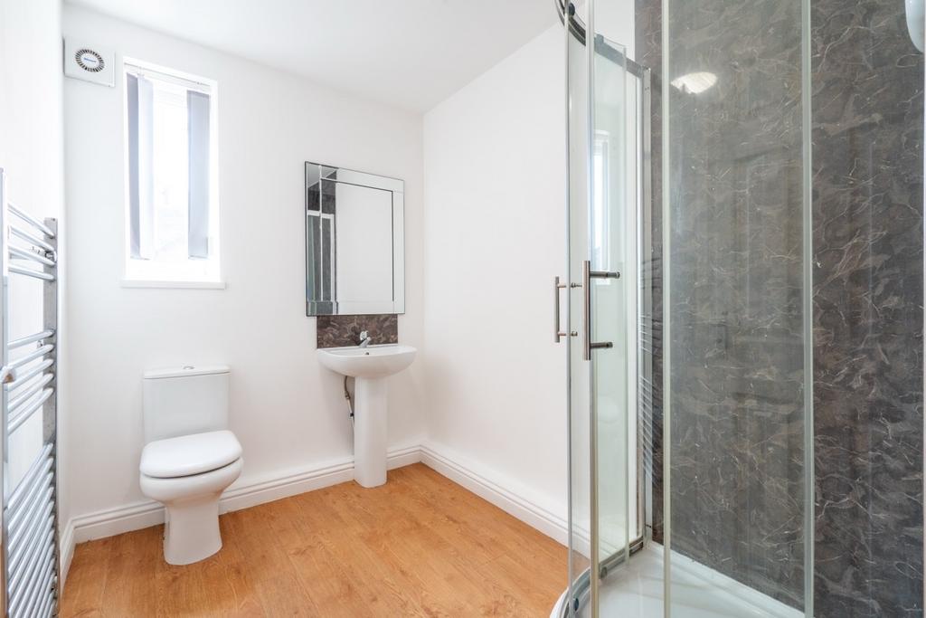 Bright and clean bathroom featuring a modern sh...