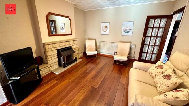 A bright and welcoming living room with wooden ...