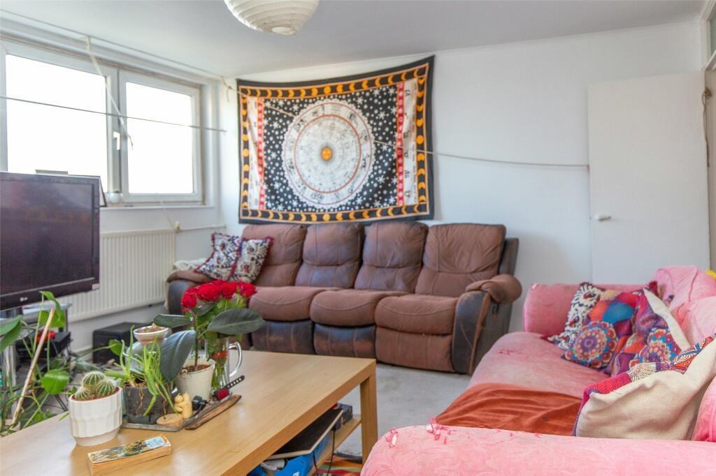 Bright and welcoming living room with ample nat...