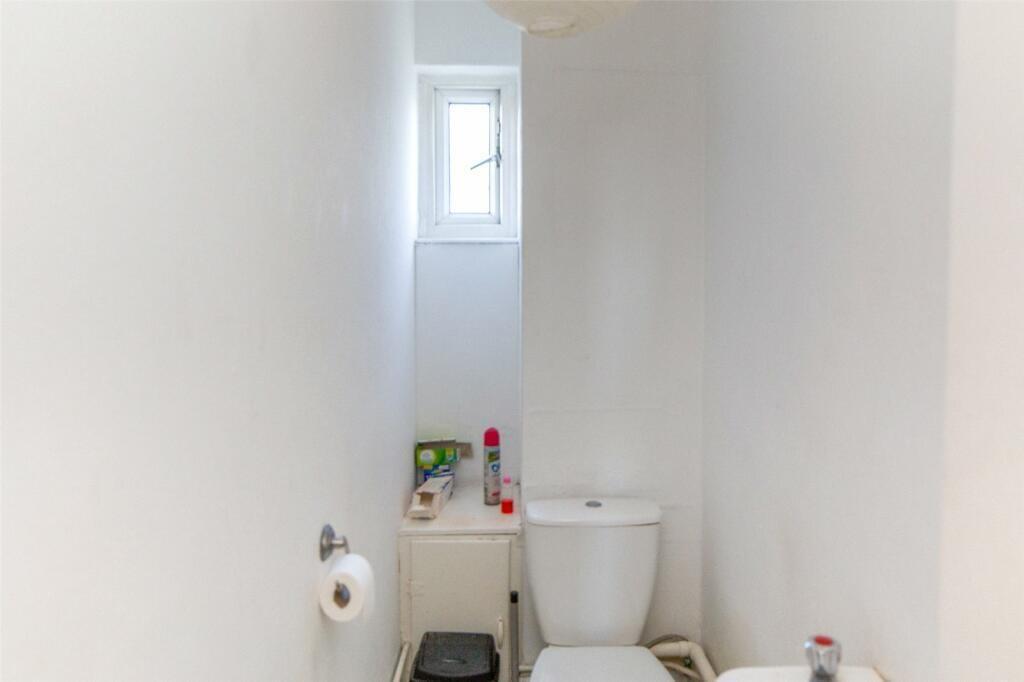 A clean, bright bathroom with a modern toilet a...