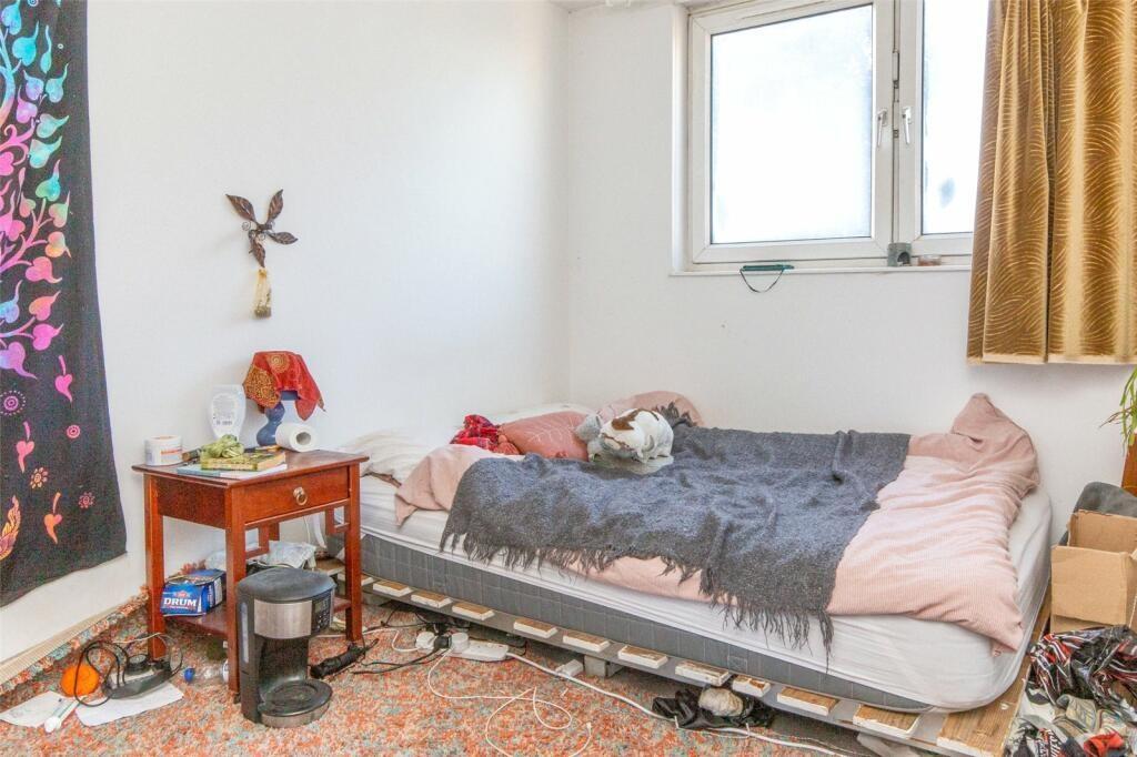 A cozy private bedroom featuring a single bed, ...